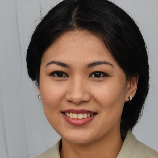Joyful asian young-adult female with medium  brown hair and brown eyes