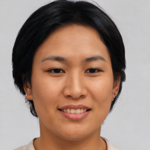 Joyful asian young-adult female with medium  brown hair and brown eyes