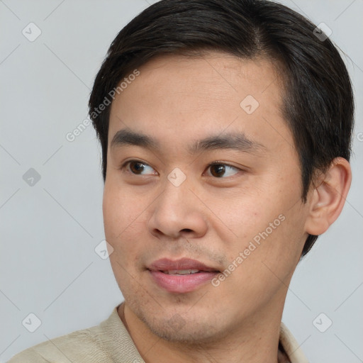 Joyful asian young-adult male with short  brown hair and brown eyes