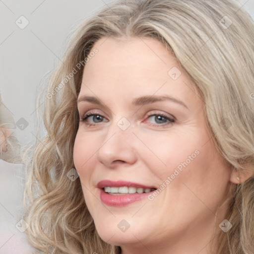 Joyful white young-adult female with long  brown hair and blue eyes