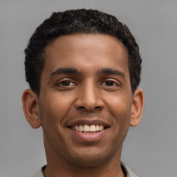 Joyful latino young-adult male with short  brown hair and brown eyes