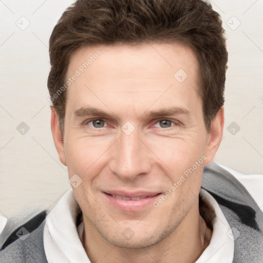 Joyful white adult male with short  brown hair and grey eyes