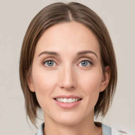 Joyful white young-adult female with medium  brown hair and green eyes