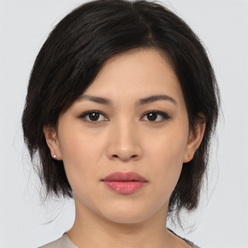 Joyful asian young-adult female with medium  black hair and brown eyes