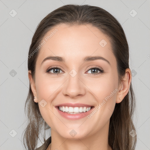 Joyful white young-adult female with long  brown hair and grey eyes