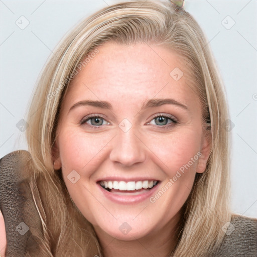 Joyful white young-adult female with long  brown hair and blue eyes