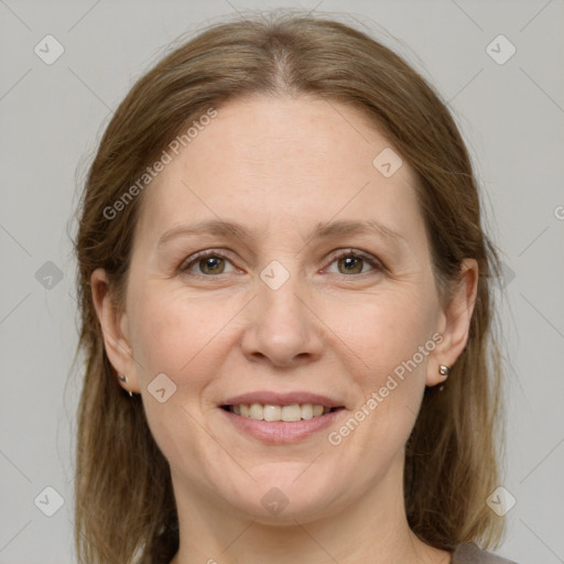 Joyful white adult female with medium  brown hair and grey eyes