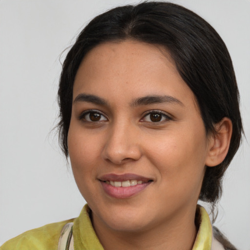 Joyful latino young-adult female with medium  brown hair and brown eyes