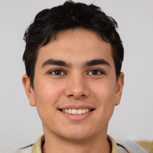 Joyful latino young-adult male with short  brown hair and brown eyes