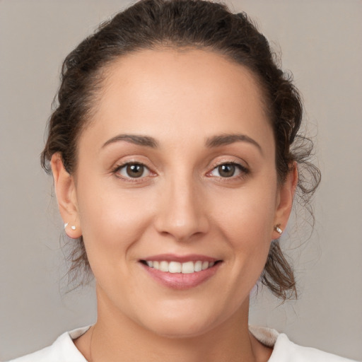 Joyful white young-adult female with medium  brown hair and brown eyes