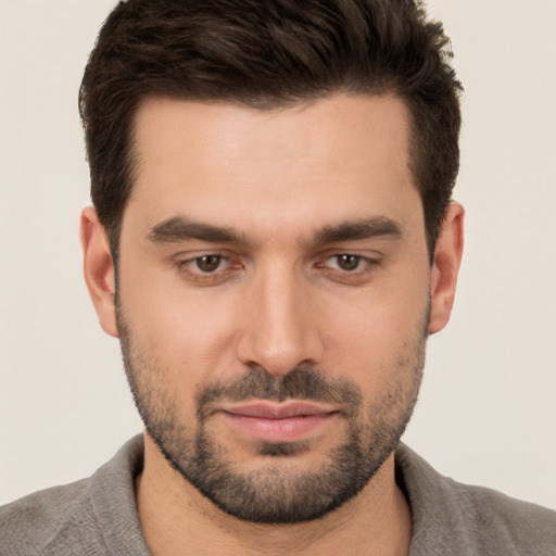 Joyful white young-adult male with short  brown hair and brown eyes