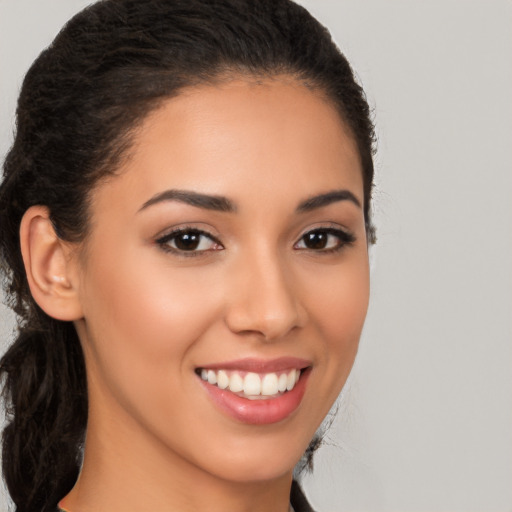 Joyful latino young-adult female with long  brown hair and brown eyes