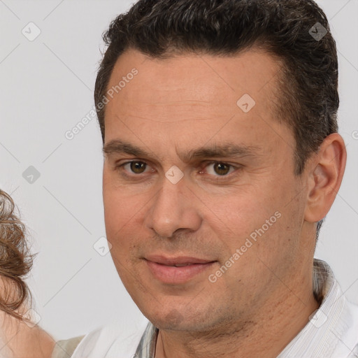 Joyful white adult male with short  brown hair and brown eyes