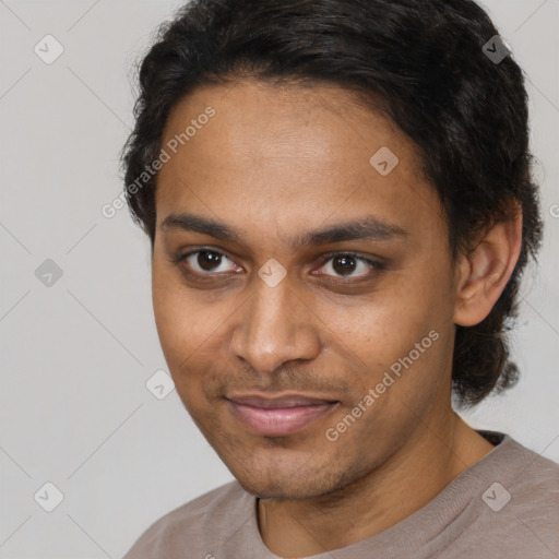 Joyful black young-adult male with short  brown hair and brown eyes