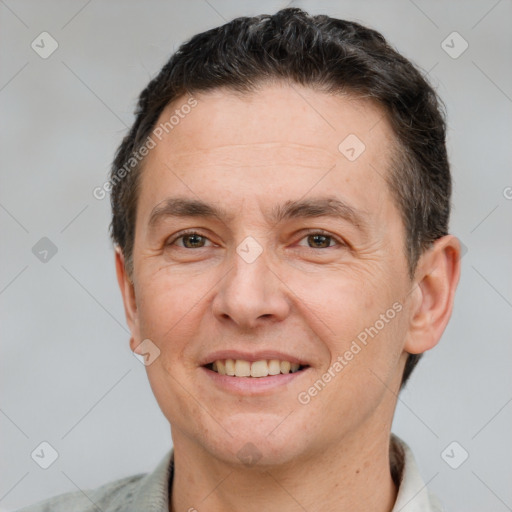 Joyful white adult male with short  brown hair and brown eyes