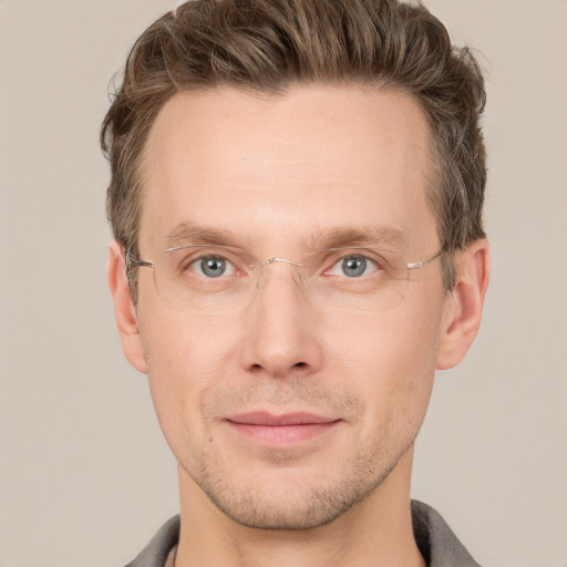 Joyful white adult male with short  brown hair and grey eyes