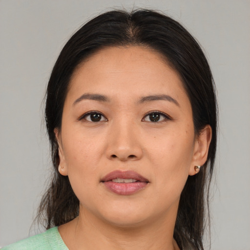 Joyful asian young-adult female with medium  brown hair and brown eyes