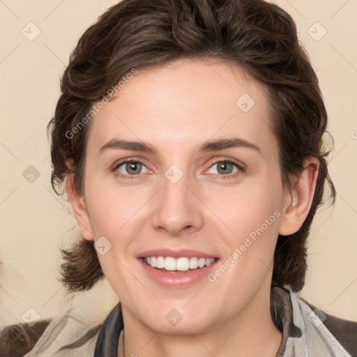 Joyful white young-adult female with medium  brown hair and green eyes