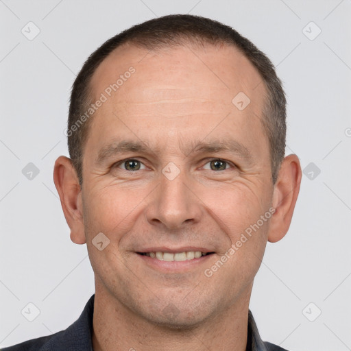 Joyful white adult male with short  brown hair and brown eyes