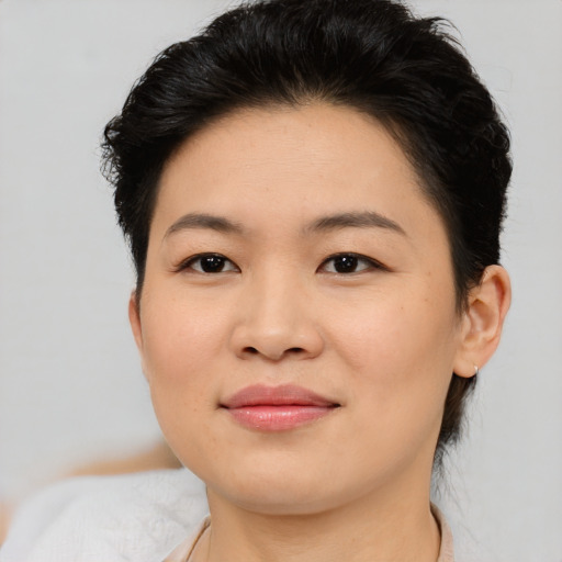 Joyful asian young-adult female with short  brown hair and brown eyes