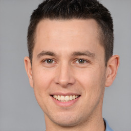 Joyful white young-adult male with short  brown hair and brown eyes