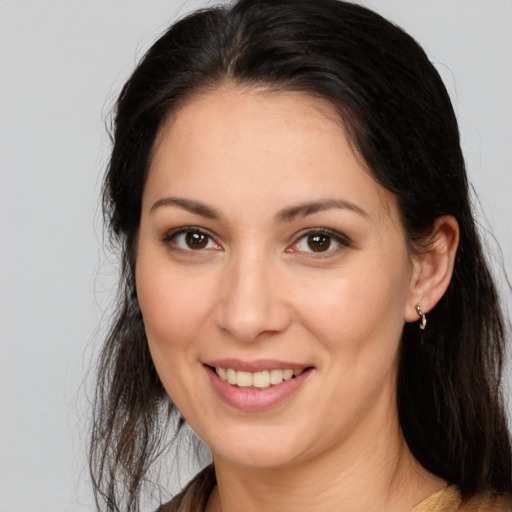 Joyful white young-adult female with long  brown hair and brown eyes