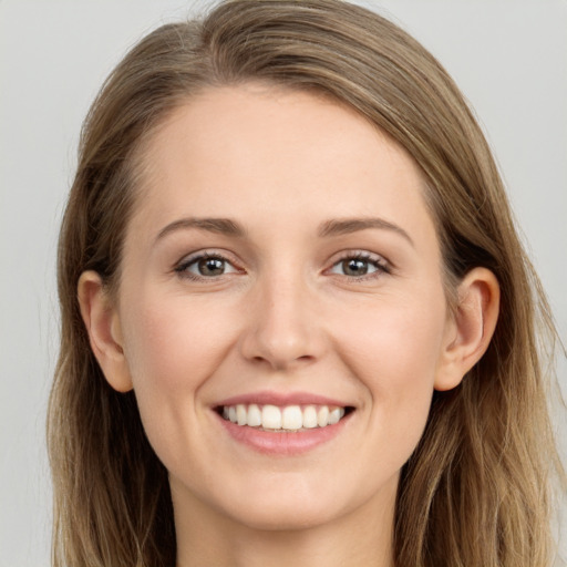 Joyful white young-adult female with long  brown hair and grey eyes