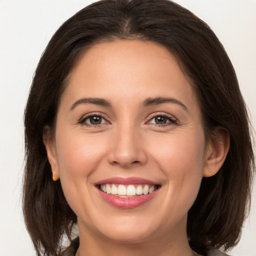 Joyful white young-adult female with medium  brown hair and brown eyes