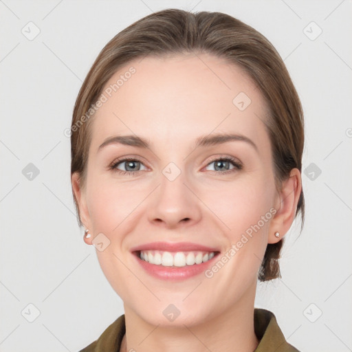 Joyful white young-adult female with medium  brown hair and grey eyes