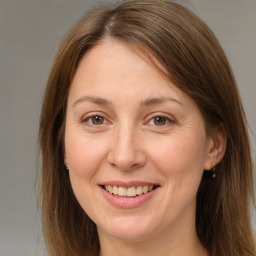 Joyful white adult female with medium  brown hair and brown eyes