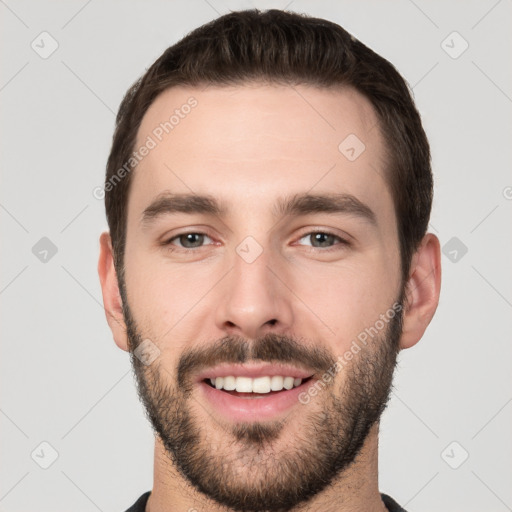 Joyful white young-adult male with short  black hair and brown eyes