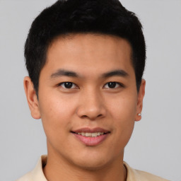 Joyful asian young-adult male with short  brown hair and brown eyes