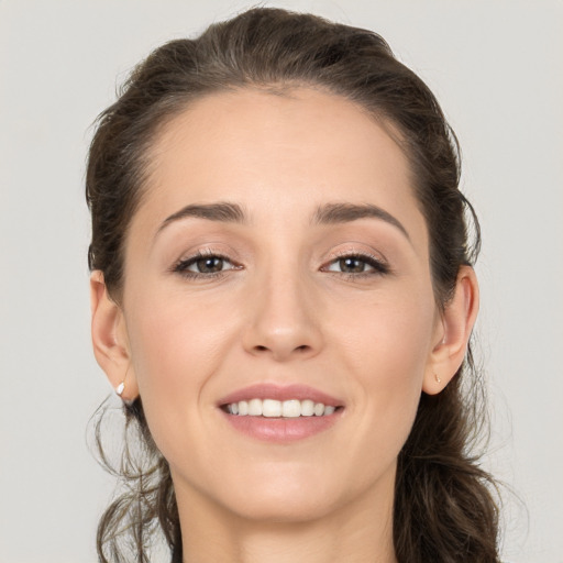 Joyful white young-adult female with long  brown hair and grey eyes