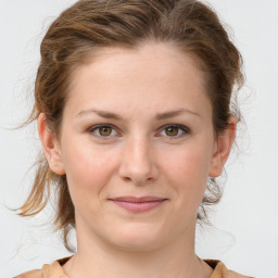 Joyful white young-adult female with medium  brown hair and blue eyes