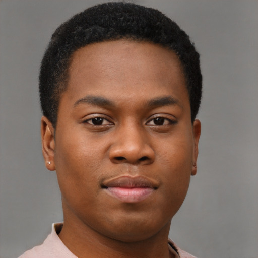 Joyful black young-adult male with short  brown hair and brown eyes