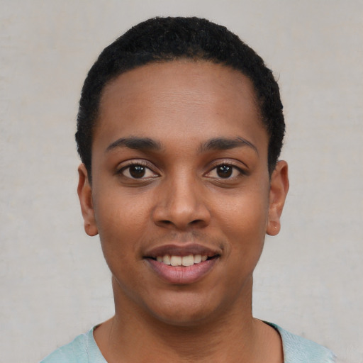 Joyful black young-adult female with short  black hair and brown eyes