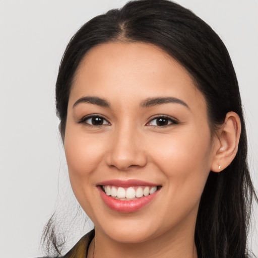 Joyful white young-adult female with long  brown hair and brown eyes