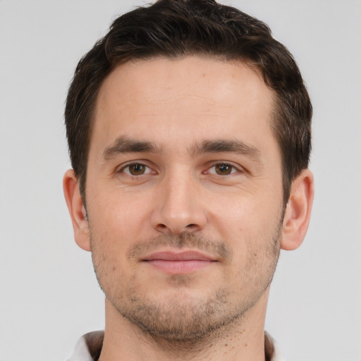 Joyful white young-adult male with short  brown hair and brown eyes