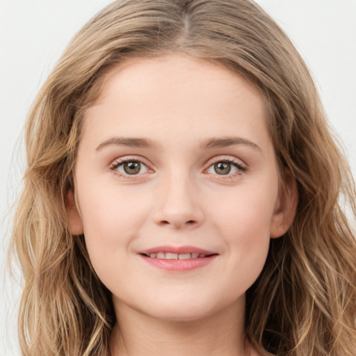 Joyful white child female with long  brown hair and green eyes