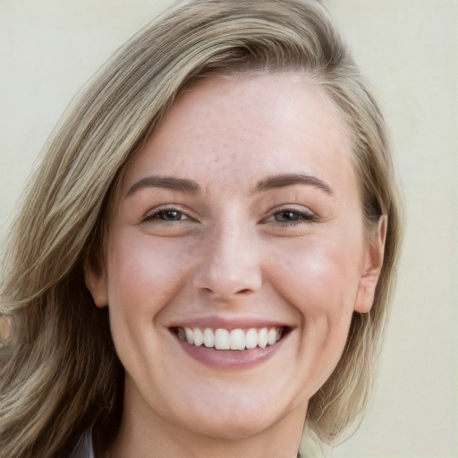 Joyful white young-adult female with long  brown hair and blue eyes