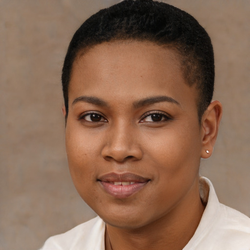 Joyful black young-adult female with short  brown hair and brown eyes