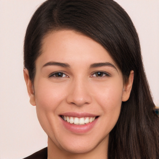 Joyful white young-adult female with long  brown hair and brown eyes