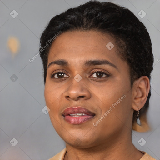 Joyful black young-adult female with short  black hair and brown eyes