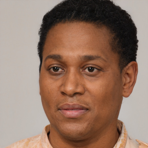 Joyful latino adult male with short  black hair and brown eyes