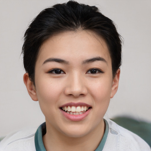 Joyful asian young-adult female with short  brown hair and brown eyes