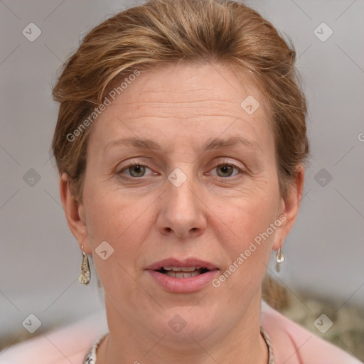 Joyful white adult female with medium  brown hair and grey eyes