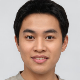 Joyful asian young-adult male with short  brown hair and brown eyes