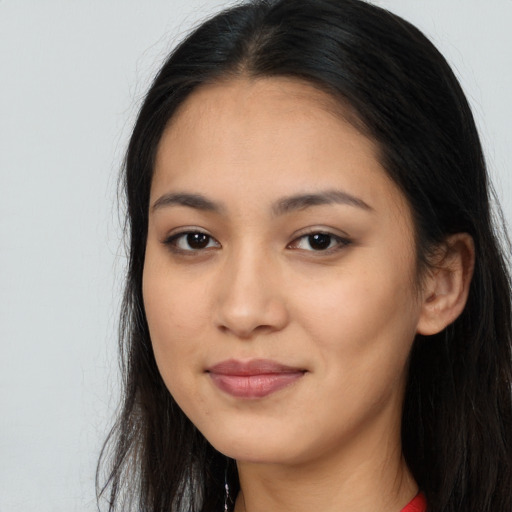 Joyful latino young-adult female with long  brown hair and brown eyes