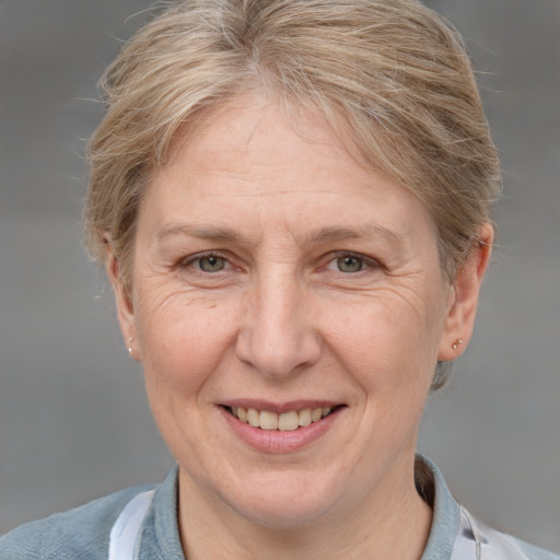 Joyful white middle-aged female with short  brown hair and grey eyes