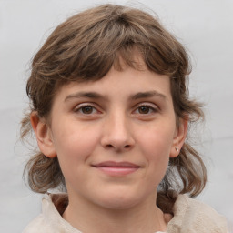 Joyful white child female with medium  brown hair and grey eyes